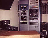 Production: console in foreground, equipment racks at rear