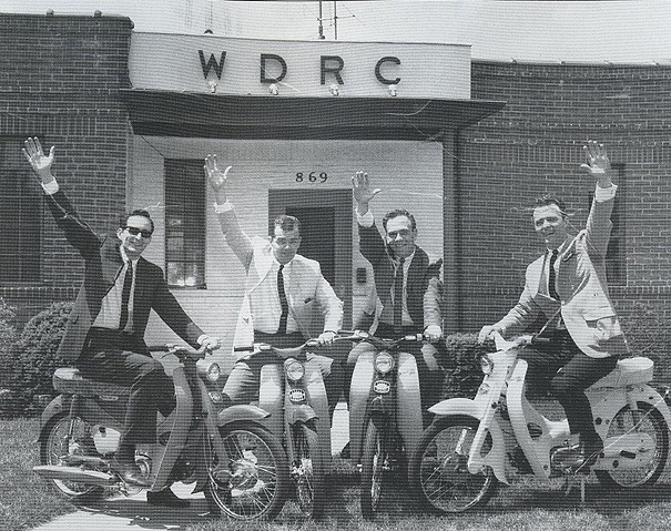 Trying out the contest prizes - (l-r:) deejays Long John Wade, Dick Robinson, Jim Nettleton and Ron Landry in front of 869 Blue Hills AVenue.