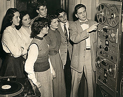 WDRC production manager Charlie Parker explains the finer points of tape recording to a group of high school students, circa 1950
